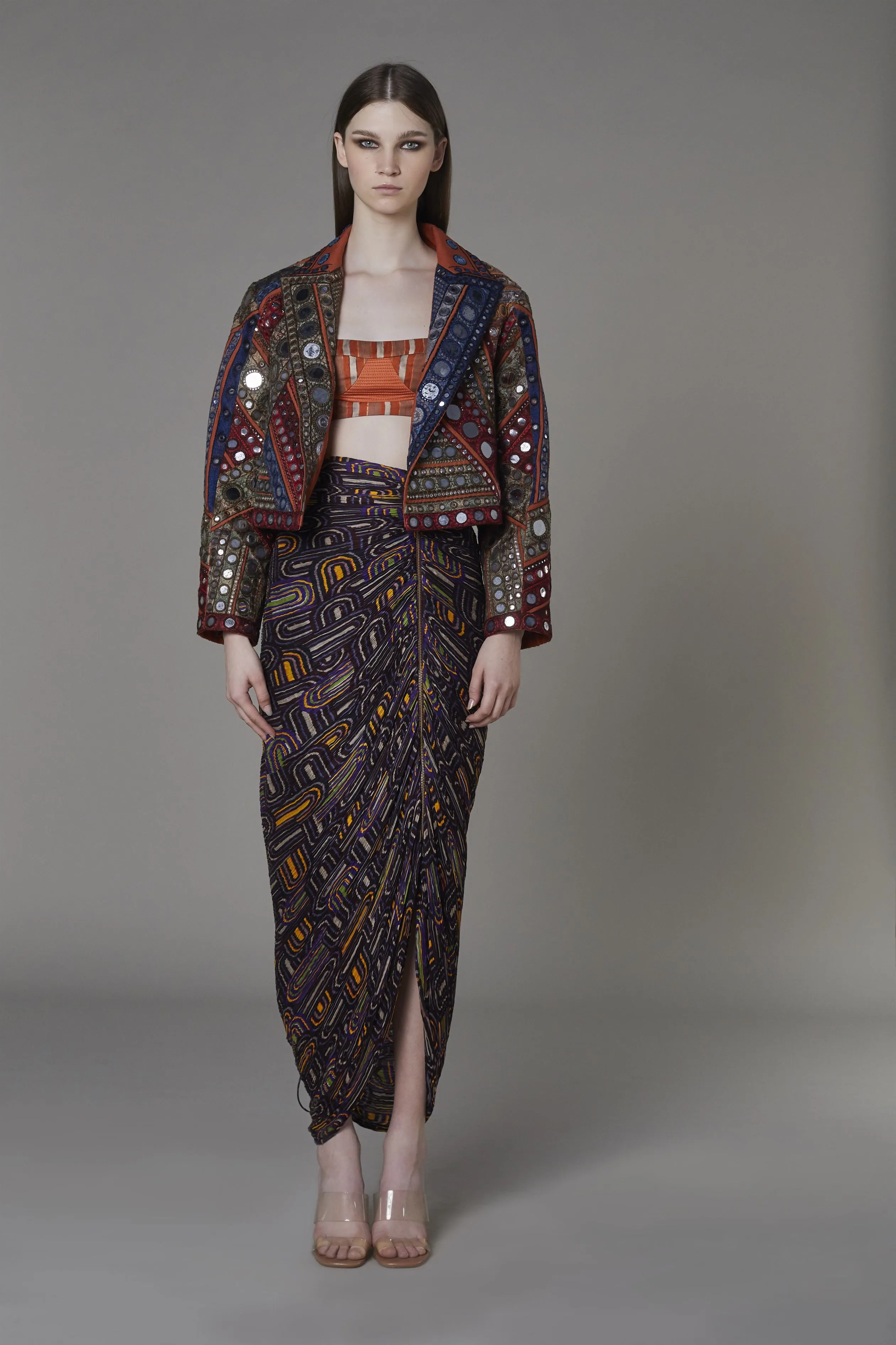 Saaksha & KinniÂ    I   Rust mirror embroidered jacket  Brown rust stripe bustier   Purple semi circle zipper beach skirt Jacket - Drill  Bustier - Satin  Skirt - Cotton Silk Jacket - Rust  Bustier - Rust  Skirt - Purple   SS22002    SS22111    SS22112