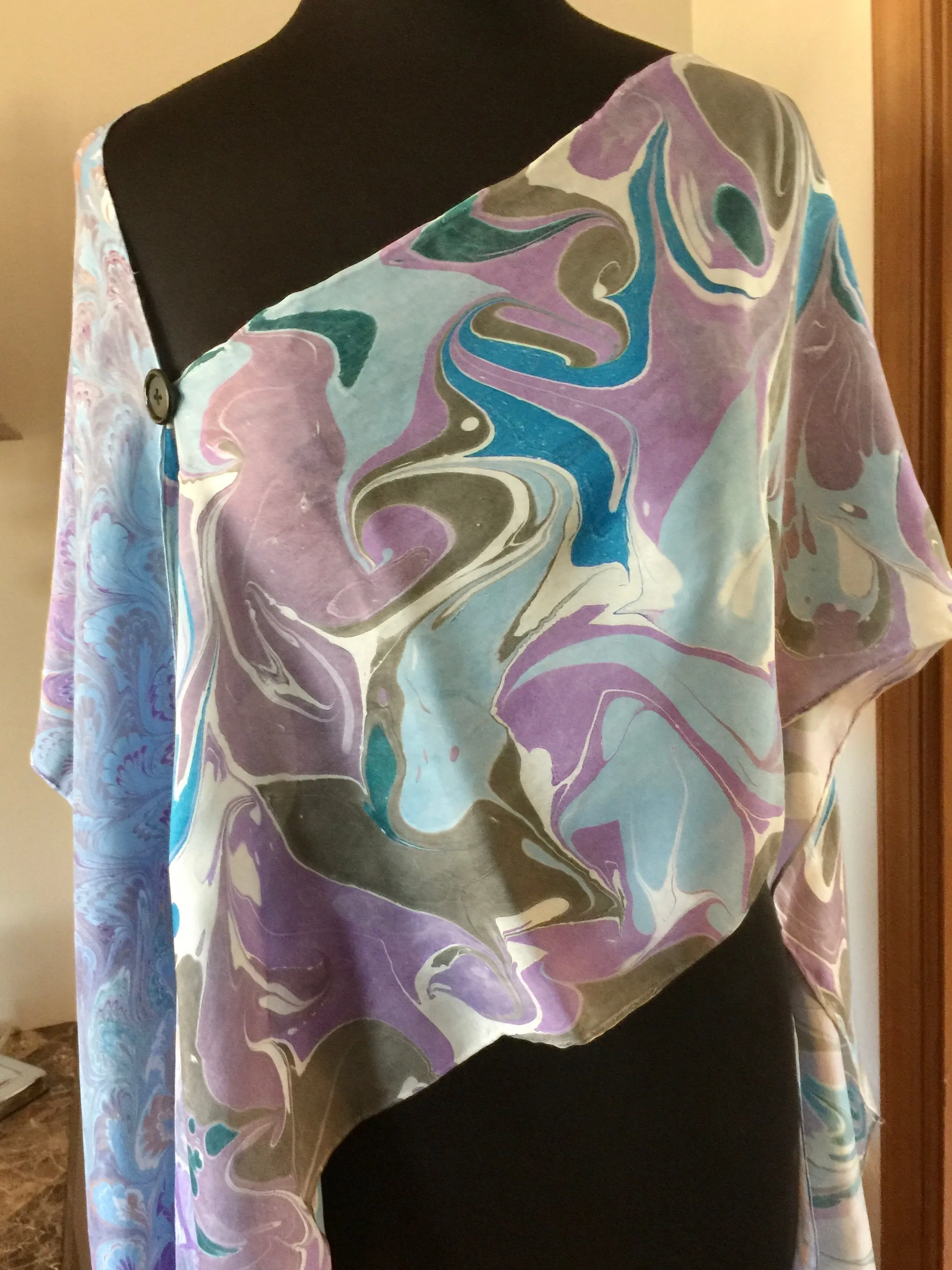 The Shibumi.  It’s a wrap, a shawl, a fashion statement!  Wear it 10 different ways!